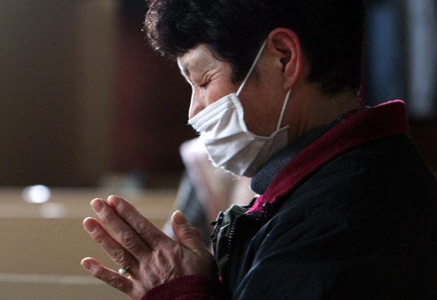 A Woman Prays For Earthquake Victimas in Japan 